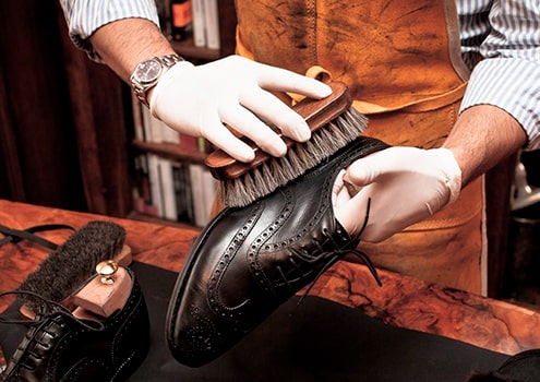 Craftsman repairing shoes with precision and care